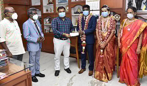 Sharinraj and Surya giving their donation to district collector | Express