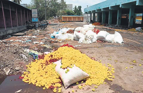 With the sales of flowers coming down during the statewide lockdown, huge heaps of unsold flowers seen trashed at Gudimalkapur flower market in Hyderabad on Tuesday | R V K Rao