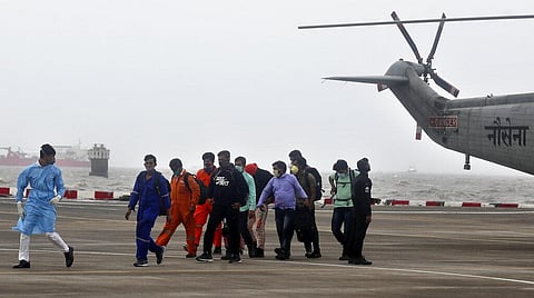 People rescued by the Indian navy from the Arabian sea arrive in a helicopter at naval air station INS Shikra in Mumbai. (Photo | AP)