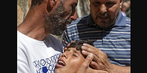 Palestinian Wael Bernat, left, comforts his crying son Ahmad during the funeral of his other son Islam Bernat, 16, in the West Bank city of Ramallah. (Photo | AP)