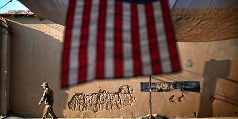 An US Army soldier walks past an American Flag at Forward Operating Base Bostick in Kunar province, Afghanistan. (Photo| AP)