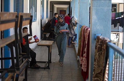 Palestinians take shelter at a school run by the U.N. after fleeing heavy Israeli missile strikes in the outskirts of Gaza City. (Photo | AP)