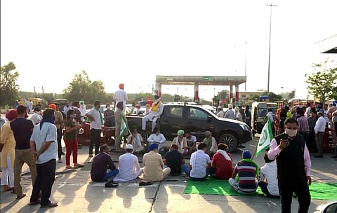 Farmers block the highway at Haryana-Punjab border at Shambhu toll plaza near Ambala on Sunday after police baton-charged farmers protesting against CM Manohar Lal Khattar in Hisar. (Photo | ANI)