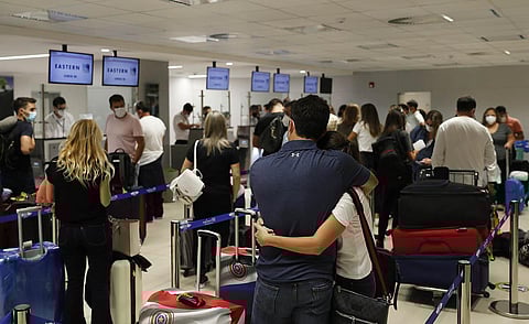 People check in for a flight to Miami at Silvio Pettirossi Airport, in Luque, Paraguay. (Photo | AP)