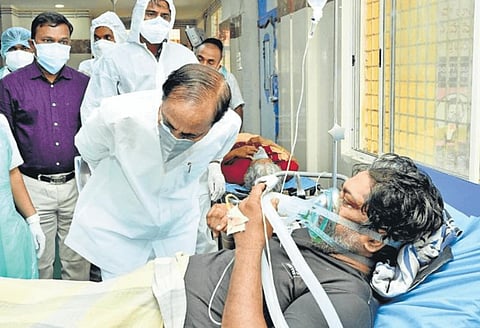Chief Minister K Chandrasekhar Rao lends an empathetic ear to a Covid-19 patient during his visit to Gandhi Hospital in Secunderabad on Wednesday.