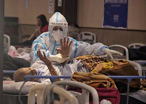 A health worker inspects COVID-19 patients. (File Photo | PTI)