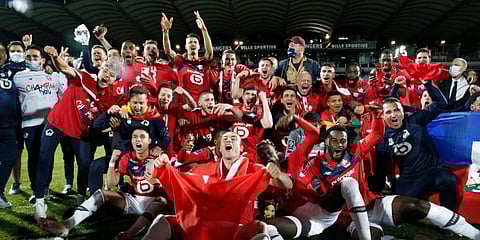 Lille players and coaches celebrate after winning the French League One title. (Photo | AP)