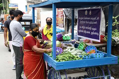 People buy vegetables from a vehicle at Adyar on Tuesday. Express/ Ashwin Prasath
