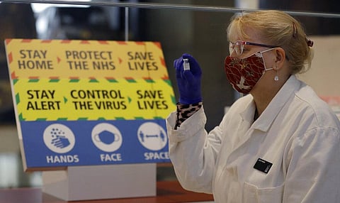 People can click on the link in their offer text and use the NHS' COVID booking website to get a reservation. (Photo | AP)