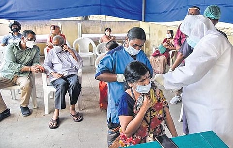 A woman takes the jab at Fever Hospital in Hyderabad as Covid vaccination drive resumed in the State on Tuesday | VINAY MADAPU