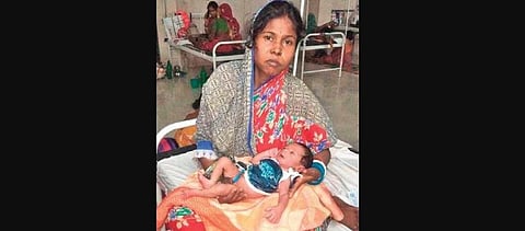 A woman with her newborn at Basudevpur health centre in Bhadrak district | Express