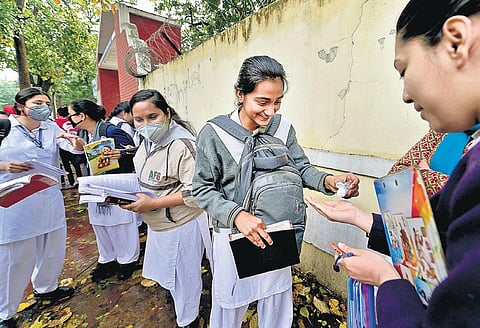 Students sanitise their hands outside a school before appearing for CBSE Class 10 and 12 exams in New Delhi. (File Photo | PTI)