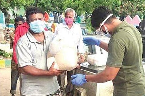 A fan of actor Chetan Kumar distributes ration kits to cemetery workers in Bengaluru, recently