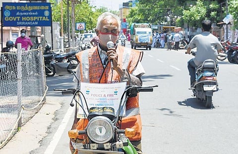 D Srinivasa Prasad announcing Covid safety norms on his mini sound system attached to his two-wheeler, in Tiruchy   | M K Ashok Kumar