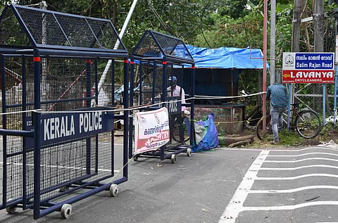 A resident waiting to enter into the containment zone near Salim Rajan Road as police closed the entrance due to triple lockdown rules. (Photo | Albin Mathew, EPS)