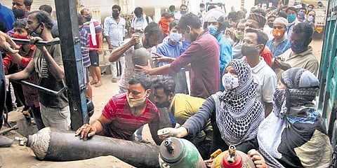 Kin of COVID patients crowd at an oxygen refilling centre in Kanpur on Sunday. (Photo | PTI)