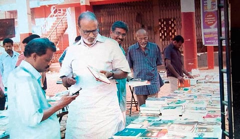 Actor V K Sreeraman at a book fair conducted by A V Sasi (behind him)