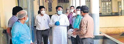 Deputy Chief Minister Laxman Savadi interacts with staff at BIMS on Saturday | Express