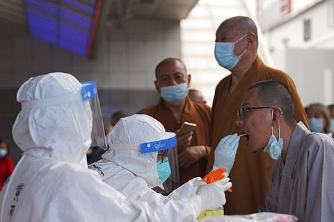 Monks get tested for the coronavirus in a district in Guangzhou in southern China's Guangdong province on Sunday, May 30, 2021. (Photo | AP)
