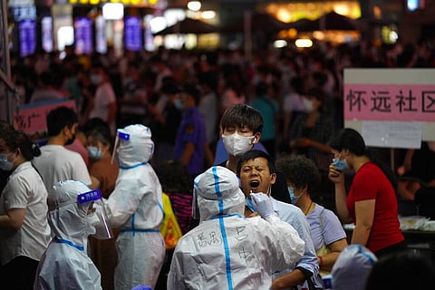 A resident gets tested for coronavirus in the Liwan District in Guangzhou in southern China's Guangdong province. (Photo | AP)