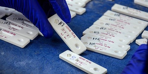 A health care worker holds a collected sample of Covid-19 test, inside a mobile testing van, amid the surge in coronavirus cases in Amritsar. (Photo | PTI)