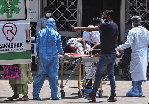 A patient suffering from Covid-19 seen on a stretcher at LNJP Hospital in Delhi on Wednesday. (Photo | Parveen Negi, EPS)