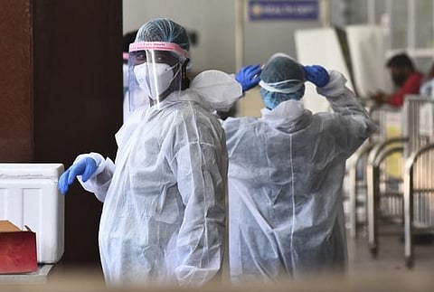 Healthcare workers gear up to test samples for COVID-19. (Photo | EPS)