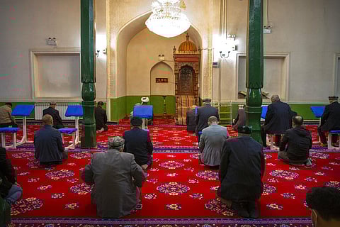 Uyghurs and other members of the faithful pray during services at Id Kah Mosque in Kashgar in western China's Xinjiang, as seen during a govt organized visit for foreign journalists. (Photo | AP)