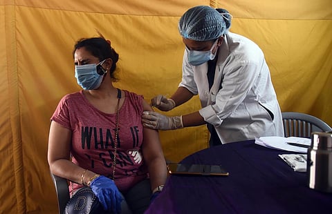 A young beneficiary receives her first dose of COVID-19 vaccine at Radha Soami Satsang in New Delhi. (Photo | Parveen Negi, EPS)