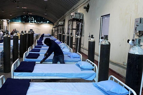 A worker cleans a newly set up C0VID- 19 hospital at Science Center in Mumbai, India. (File Photo | AP)
