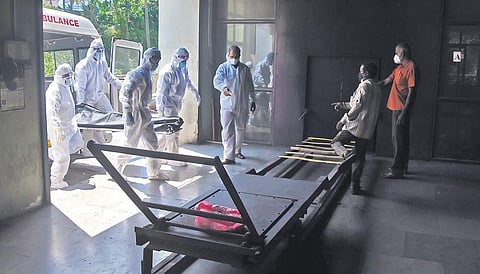 Thiruvananthapuram Corporation health workers carrying a corpse to the electric furnace at Shanthikavadam crematorium which saw 19 reservations on Thursday. The staff there, including health authoriti
