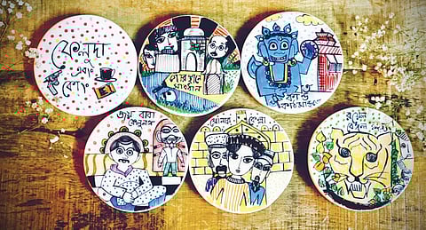 Ceramic wall plates with hand-drawn images of well-known characters from some of Ray’s films such as Sonar Kella, Jalsaghar and Nayak