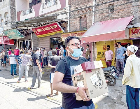People line up outside liquor stores in Delhi