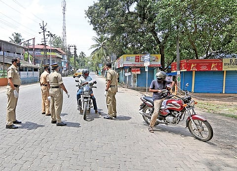 Police stop motorists for checking as part of the lockdown restrictions at Poothotta, which borders Ernakulam and Kottayam districts | Arun Angela