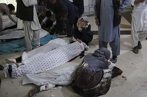 Relatives mourn inside a hospital while sitting next to bodies of victims who died in blast outside school in west Kabul district of Dasht-e-Barchi on May 8, 2021. (Photo | AFP)