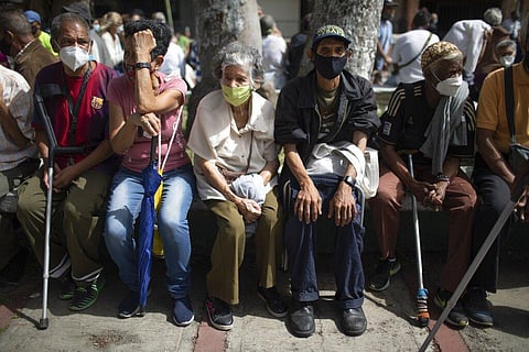 Seniors sit waiting to be vaccinated during a COVID-19 vaccination drive for seniors and those considered high risk for contagion in Venezuela.  (Photo | AP)