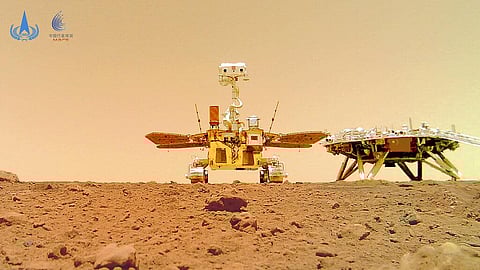 The Chinese Mars rover Zhurong is seen near its landing platform taken by a remote camera that was dropped into position by the rover. (Photo | AP)