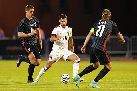 Belgium's Eden Hazard, center, is challenged by Croatia's Domagoj Vida, right, during the international friendly soccer match between Belgium and Croatia. (Photo | AP)