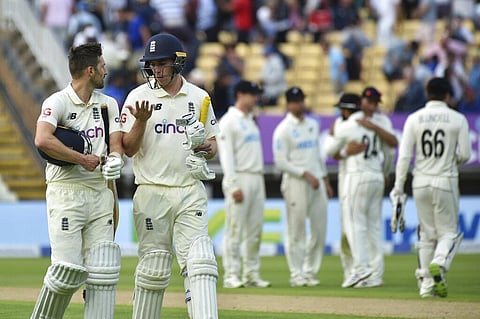 England's Mark Wood, left, and batting partner Dan Lawrence walk off the field at the end of play on the first day of the second cricket Test. (Photo | AP)