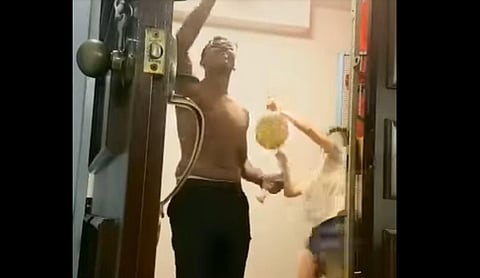 The woman bangs on a gong while her neighbour goes about doing the 5-minute prayer. (Photo | Livanesh Ramu, Facebook)