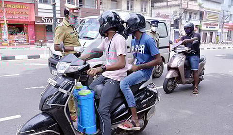 Police checking for the essential service e-pass, which is required for commuting, in Kerala. (Photo | Vincent Pulickal, EPS)