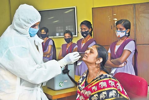 Chennai corporation staff taking swab samples from teachers and students of Government Polytechnic College at Taramani in this file photo. (Ashwin Prasath | EPS)
