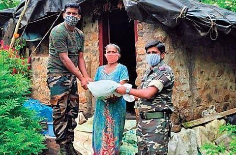 ANF personnel donate a relief kit to a woman residing in a forest in Kodagu district
