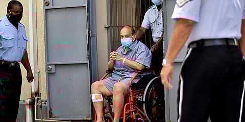 Antigua and Barbuda businessman Mehul Choksi exits in a wheelchair the magistrate's court in Roseau. (Photo| AP)