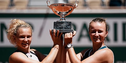 Barbora Krejcikova (R) and compatriot Katerina Siniakova hold the cup after defeating Bethanie Mattek-Sands and Iga Swiatek in their women's doubles final match of the French Open. (Photo | AP)