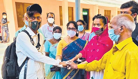 Mayor Prasanna Ernest hands over Shiva Choudary, 19, to his mother Madhu, 34 in Kollam on Saturday. 