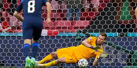 Finland's goalkeeper Lukas Hradecky makes a save against Denmark. (Photo | AP)
