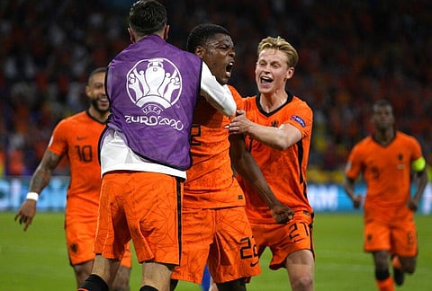 Denzel Dumfries of the Netherlands, centre, celebrates after scoring his side's third goal during the Euro 2020 soccer championship group C match between the Netherlands and Ukraine. (Photo | AP)