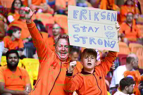Netherlands supporters hold a placard referring to Denmark's Christian Eriksen before the Euro 2020 soccer championship group C match between Netherlands and Ukraine. (Photo | AP)