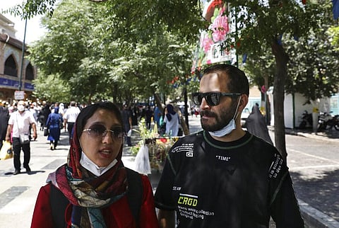 Fatemeh Rekabi, an accountant, speaks with The Associated Press about the upcoming presidential election, as she stands next to her friend Omid Alimardani, at the Grand Bazaar, in Tehran. (Photo | AP)